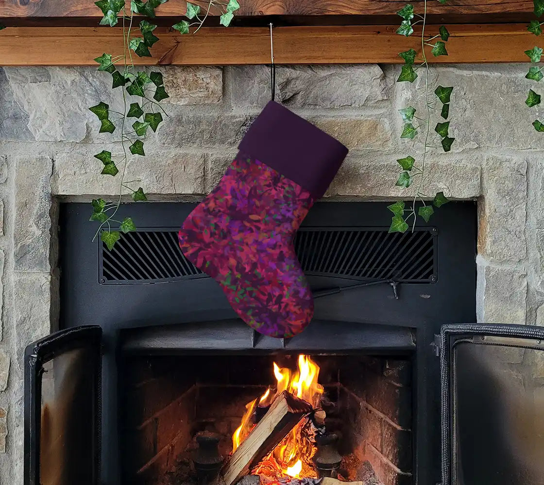 Purple and pink patterned Christmas stocking with a solid purple cuff.