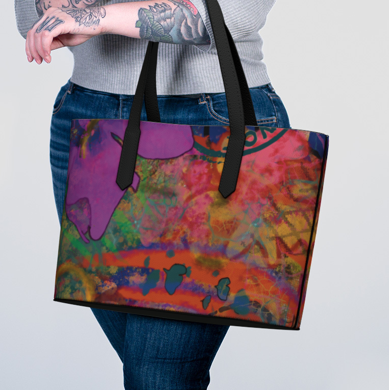 Person holding a colorful tote bag with a plain background