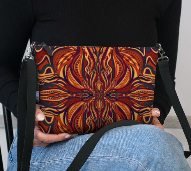 Person holding a bag with a colorful pattern on a chair