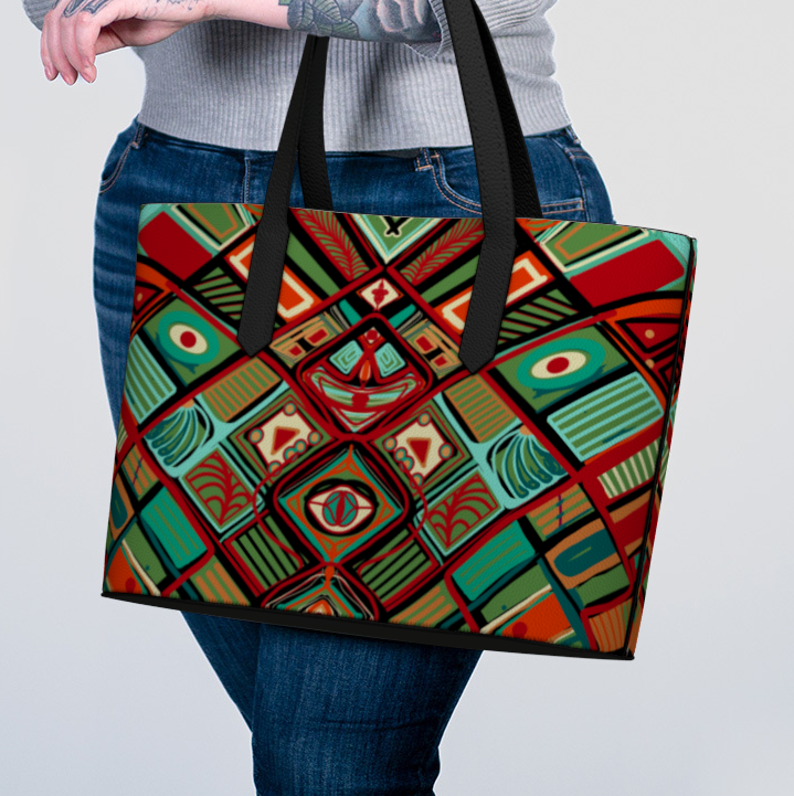 Person holding a colorful geometric patterned tote bag against a plain background