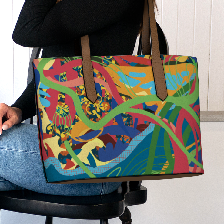 Person holding a colorful tote bag with abstract design in a home setting.