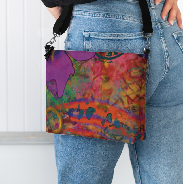Person holding a colorful handbag with a white background
