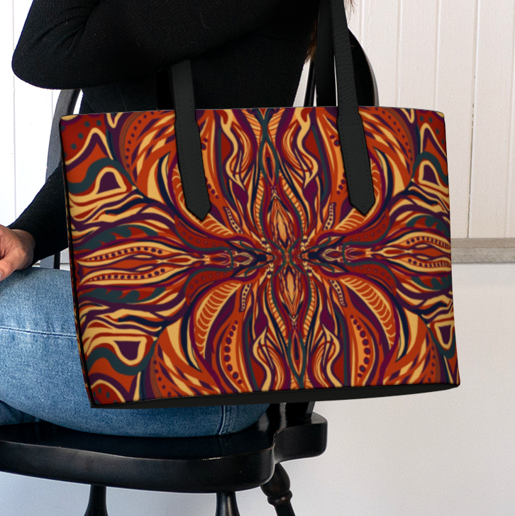 Person holding a colorful patterned bag in a room with a white wall and plant.