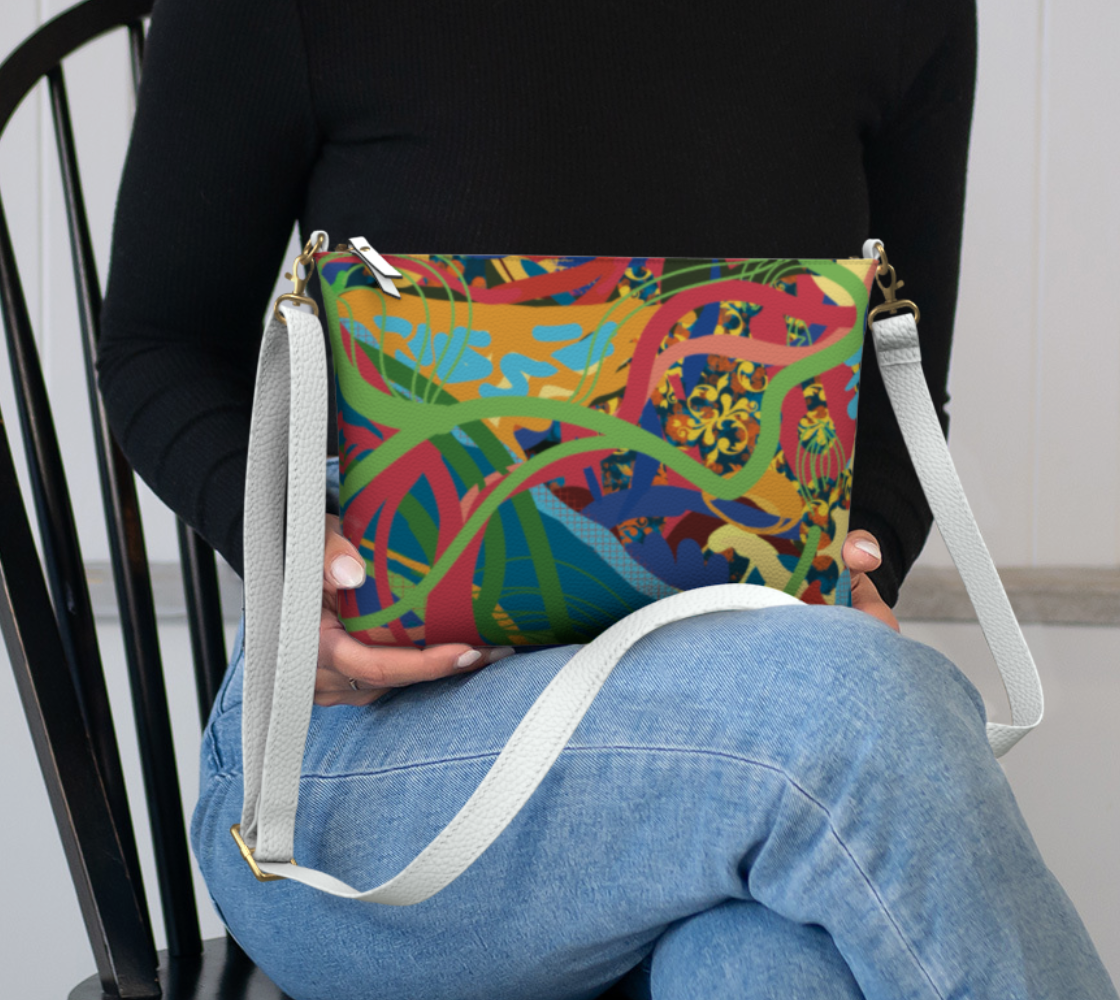 Person holding a colorful patterned bag with a white strap.